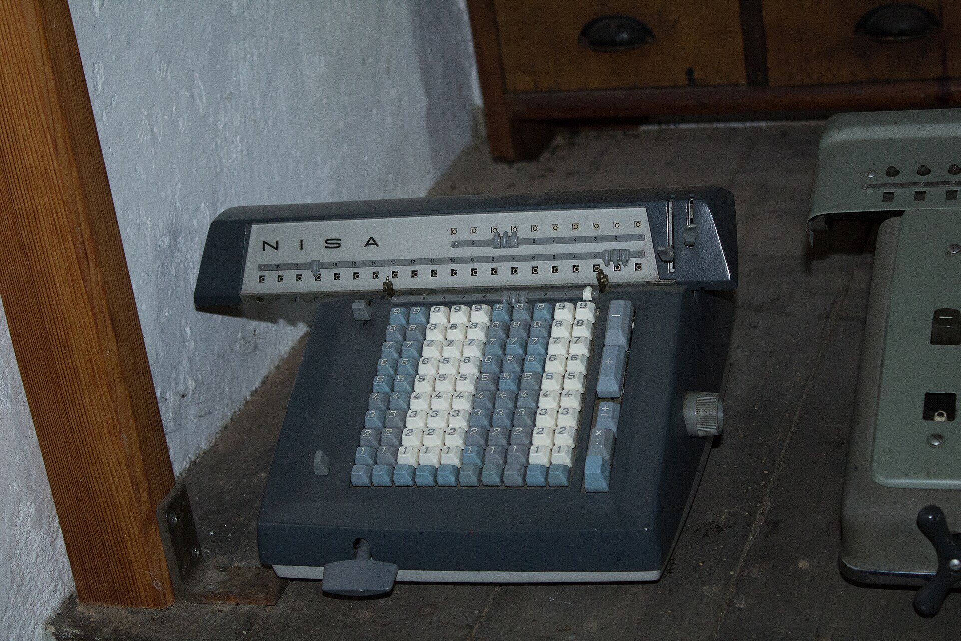 A vintage NISA mechanical calculating machine with rows of number keys