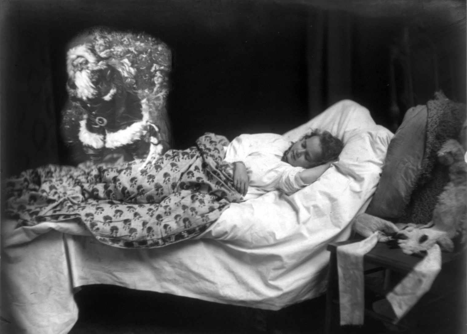 A child asleep in bed, dreaming