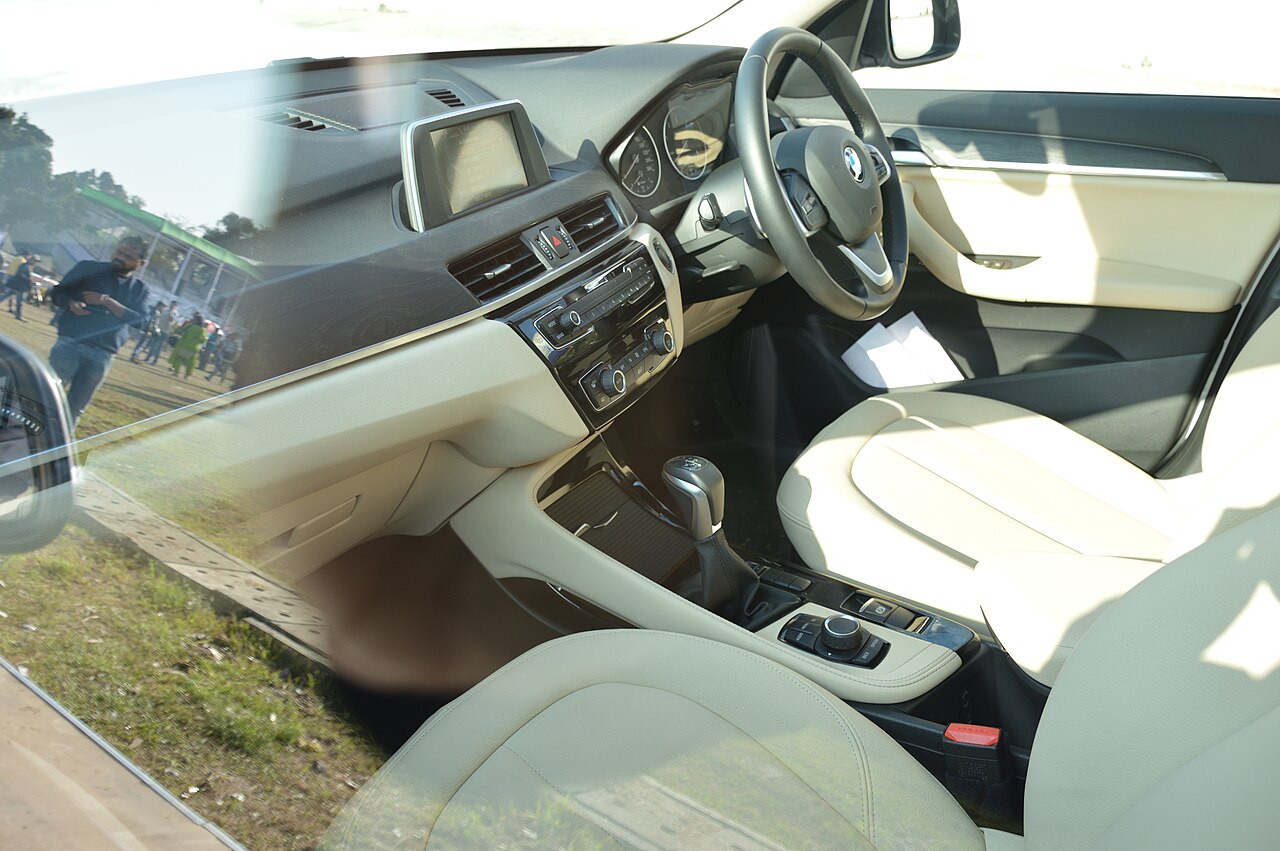 The dashboard and steering wheel of a car seen through the windscreen
