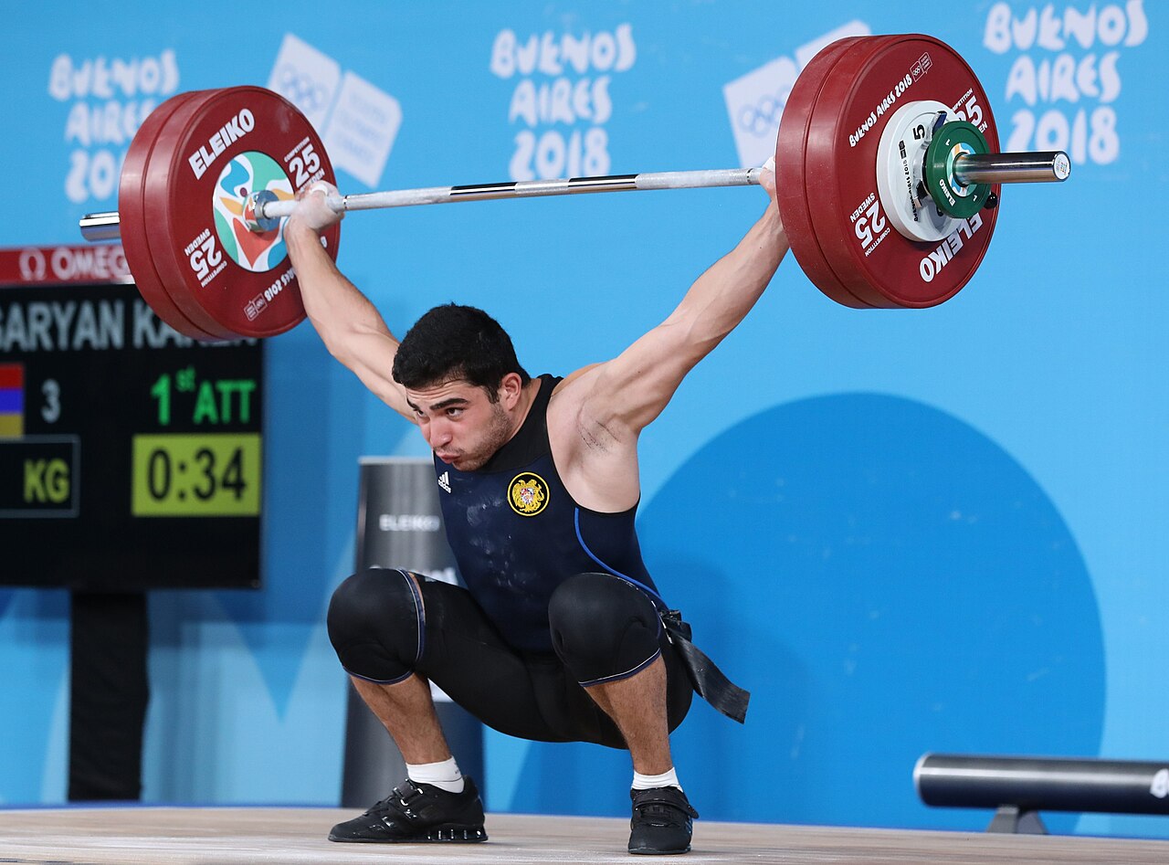 A weightlifter performing a snatch lift