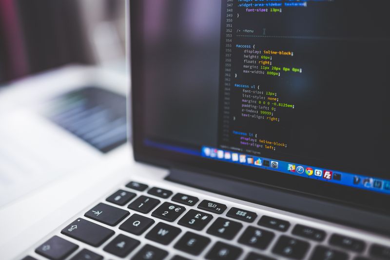 A laptop screen displaying lines of code