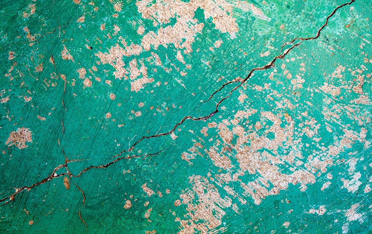 A close-up of a cracked, textured wall