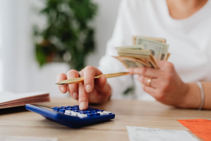 A person using a calculator at a desk