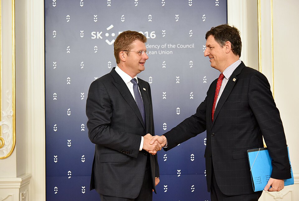 Two people shaking hands at a meeting