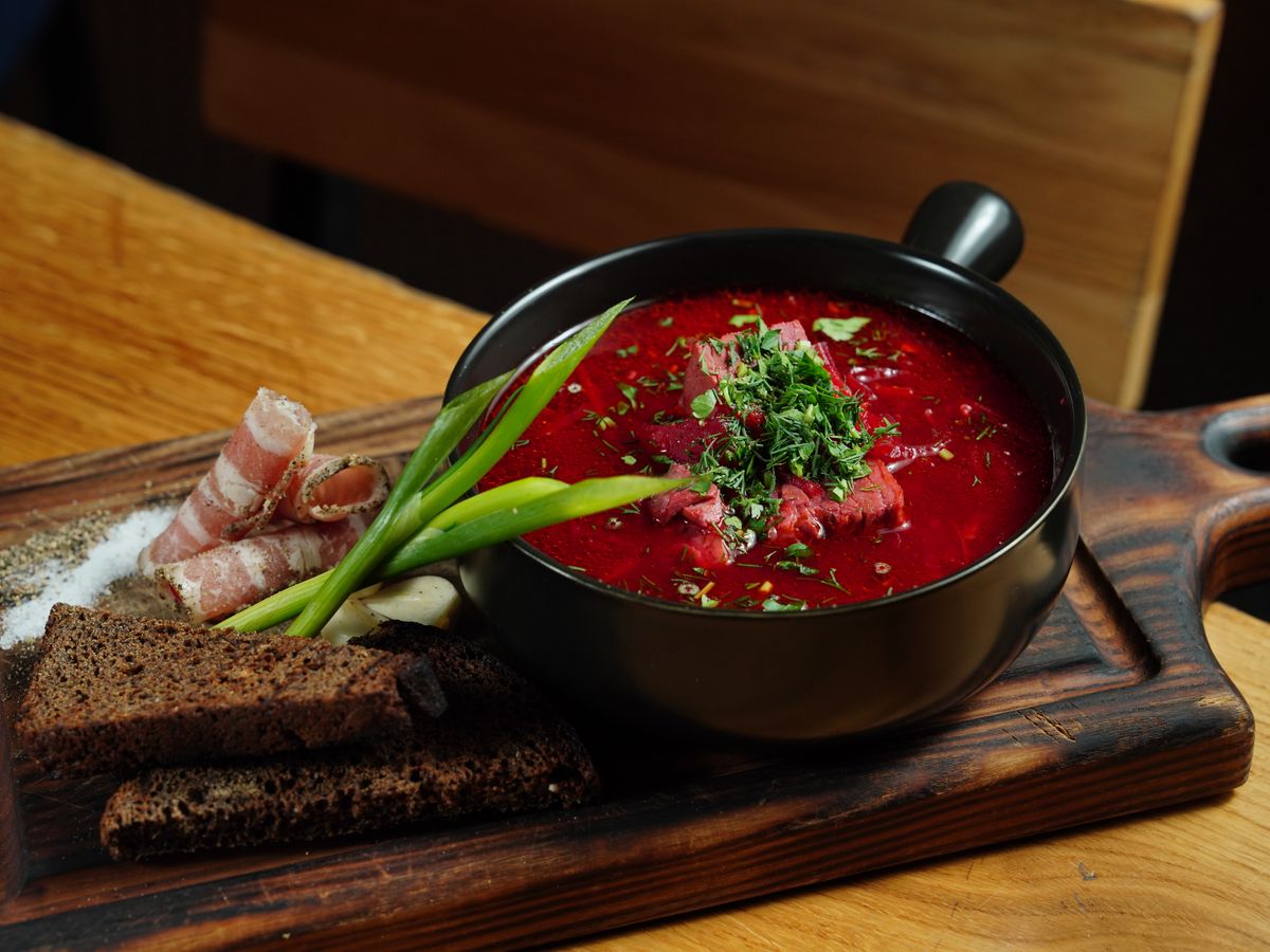 A bowl of soup on a cutting board