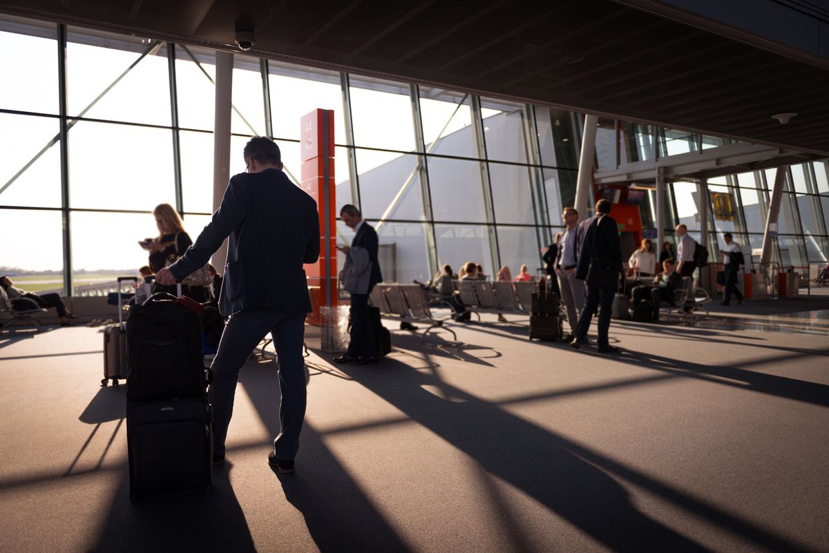Busy travellers in an airport terminal