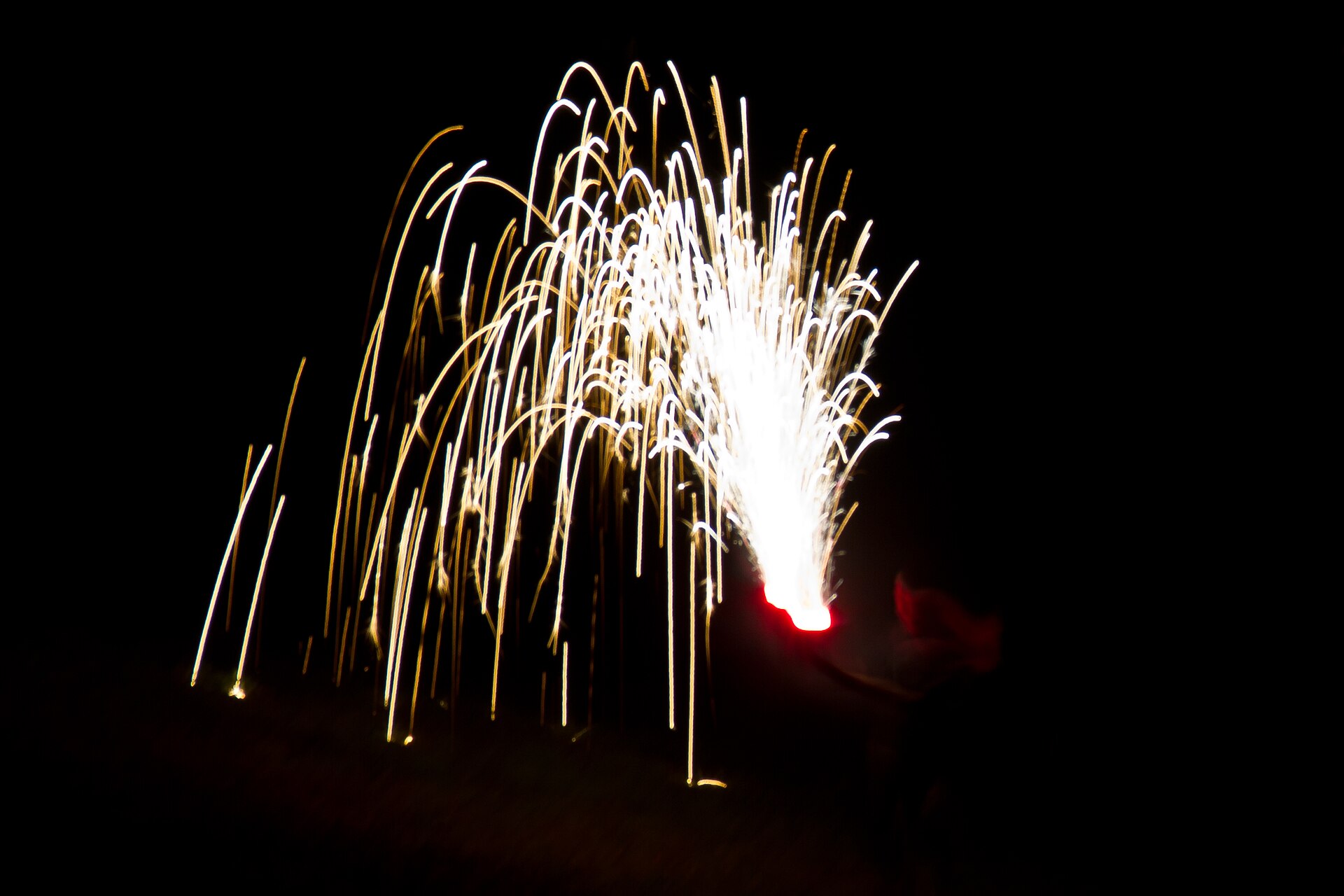 Fireworks over a neighborhood at night