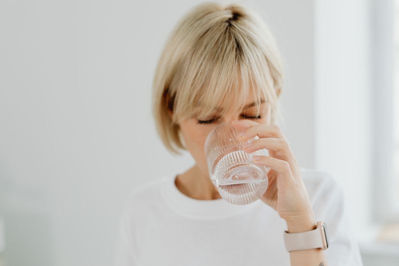 A woman drinking a glass of water