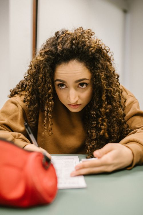 A student writing on a test paper during an exam