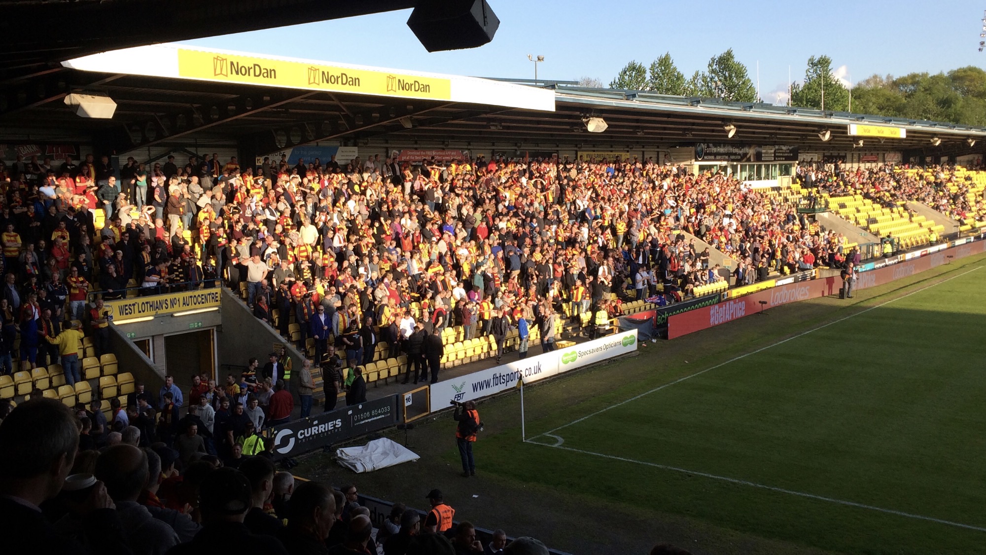 Partick Thistle fans in red and yellow fill a stand at an away ground