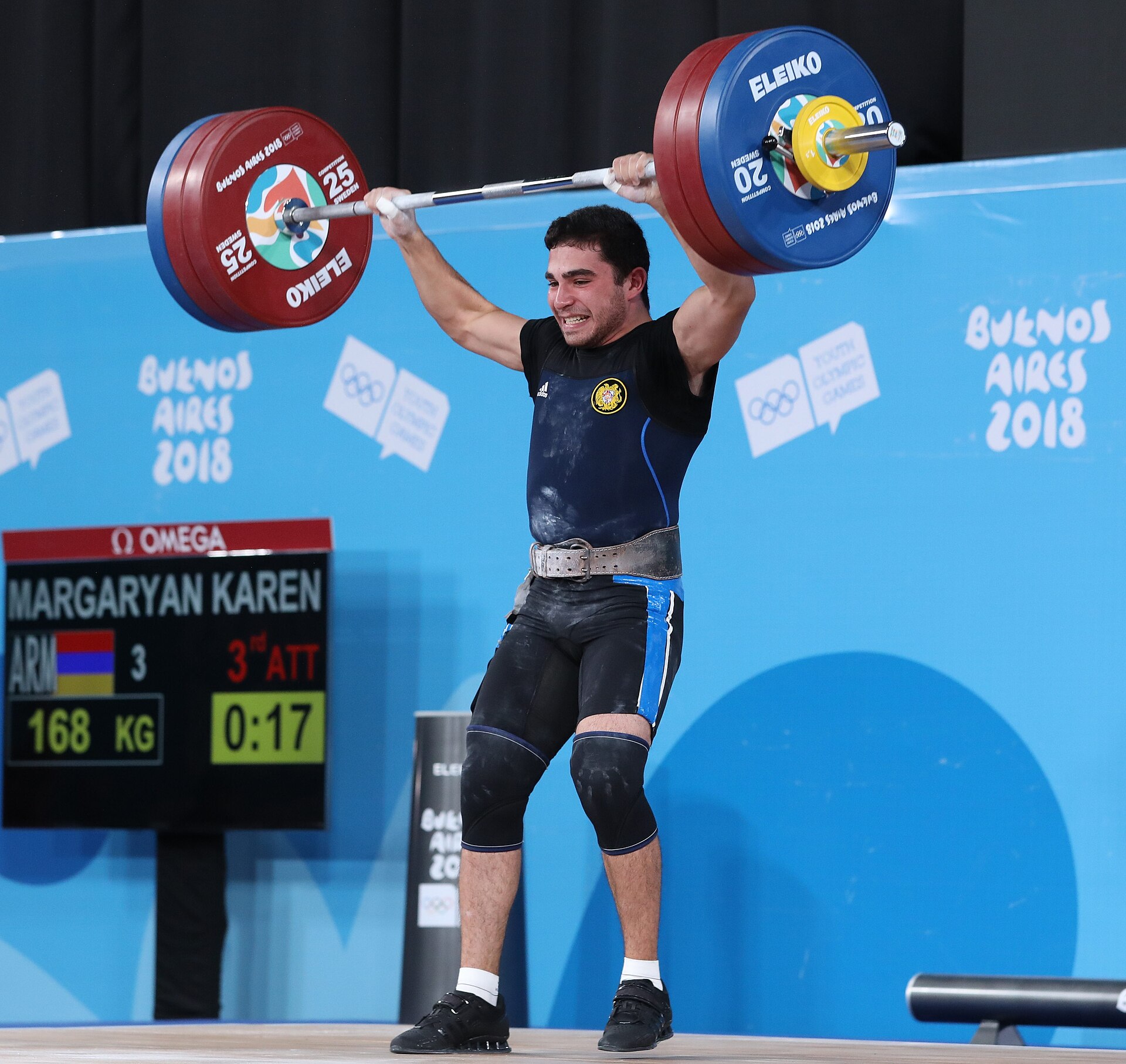 A lifter driving up from the bottom of a barbell squat