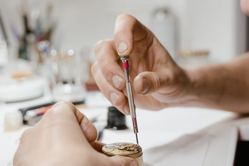 Close-up of hands using a screwdriver for detailed repair work