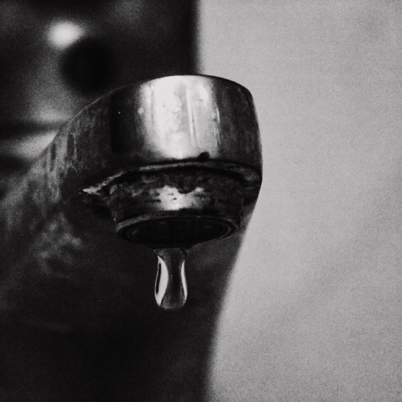 A drop of water hanging from a faucet