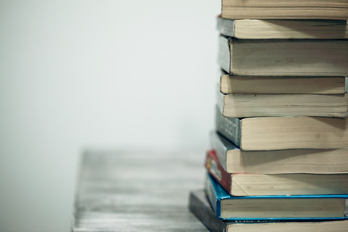 Books and handwritten notes spread on a desk