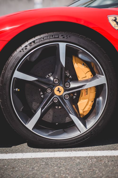 Close-up of a Ferrari wheel showing the brake caliper