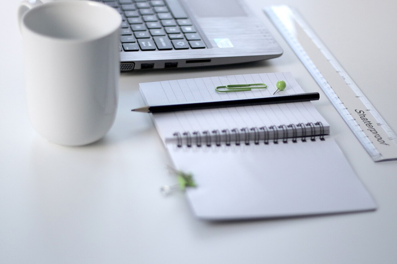 A ruler and a laptop on a desk