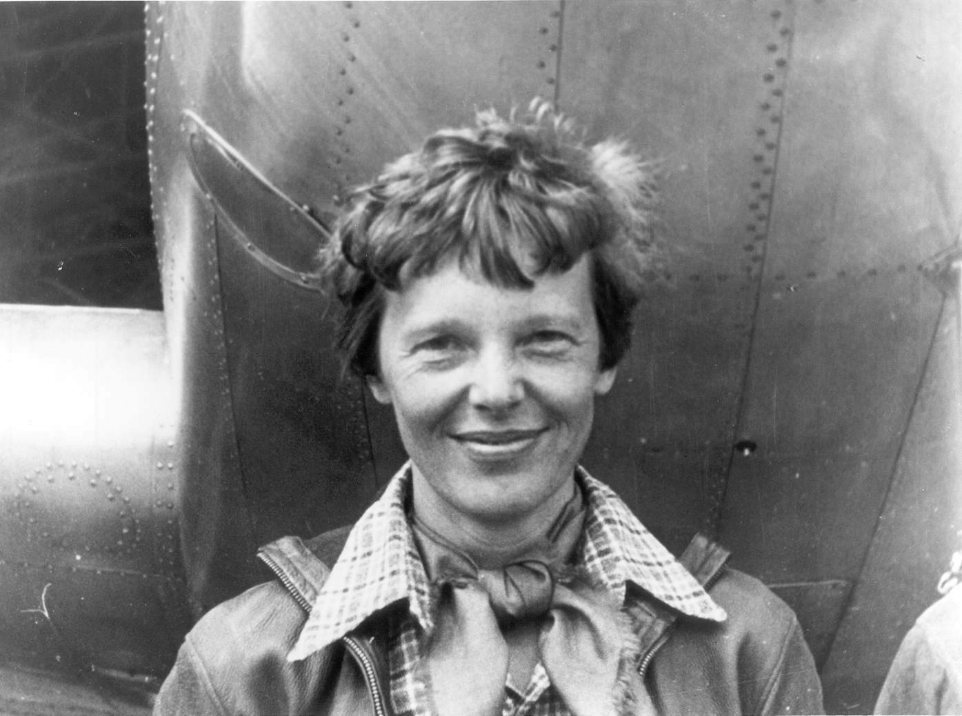 Amelia Earhart stands beside her Lockheed Model 10-E Electra in 1937