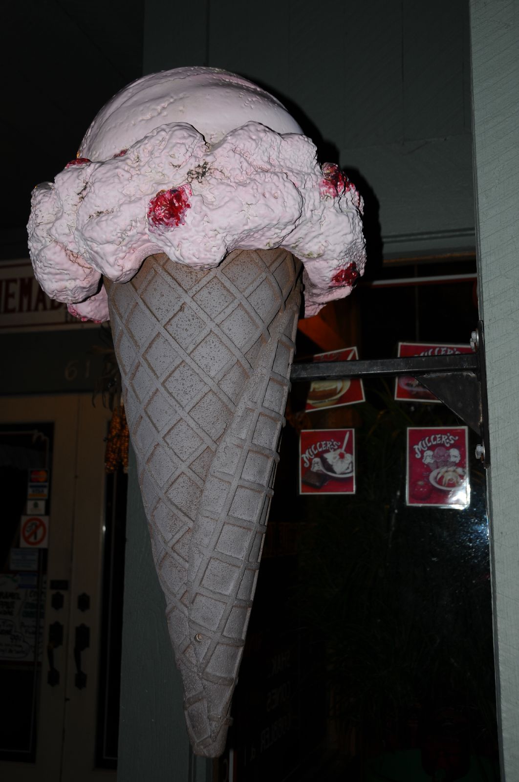 An ice cream cone held outdoors