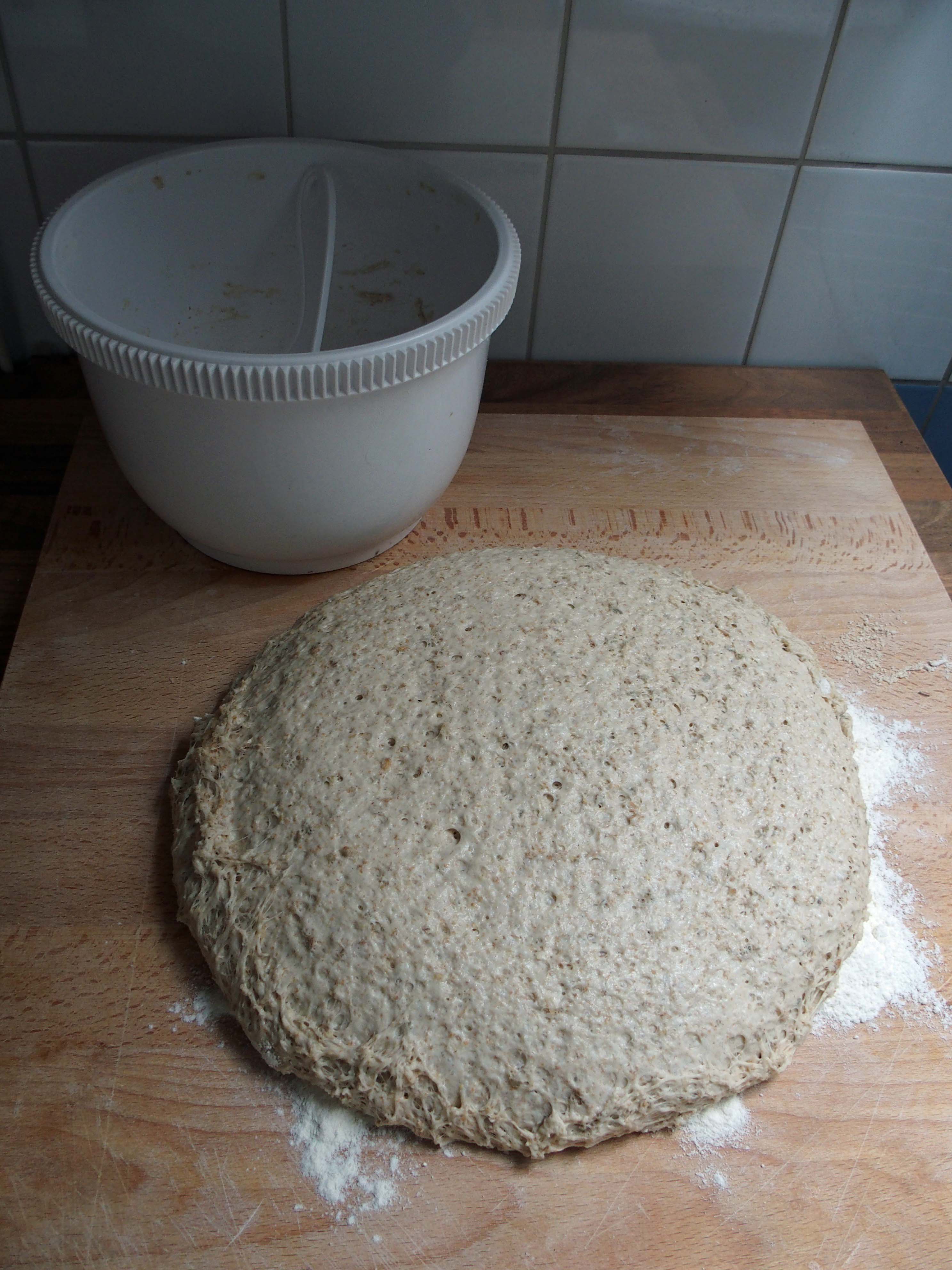 Bread dough resting in a bowl before baking