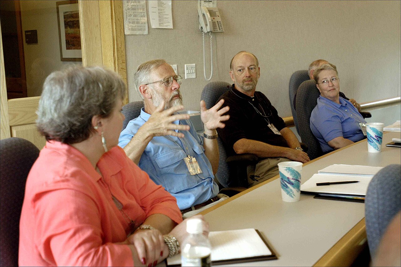 People seated at a table taking part in a group discussion