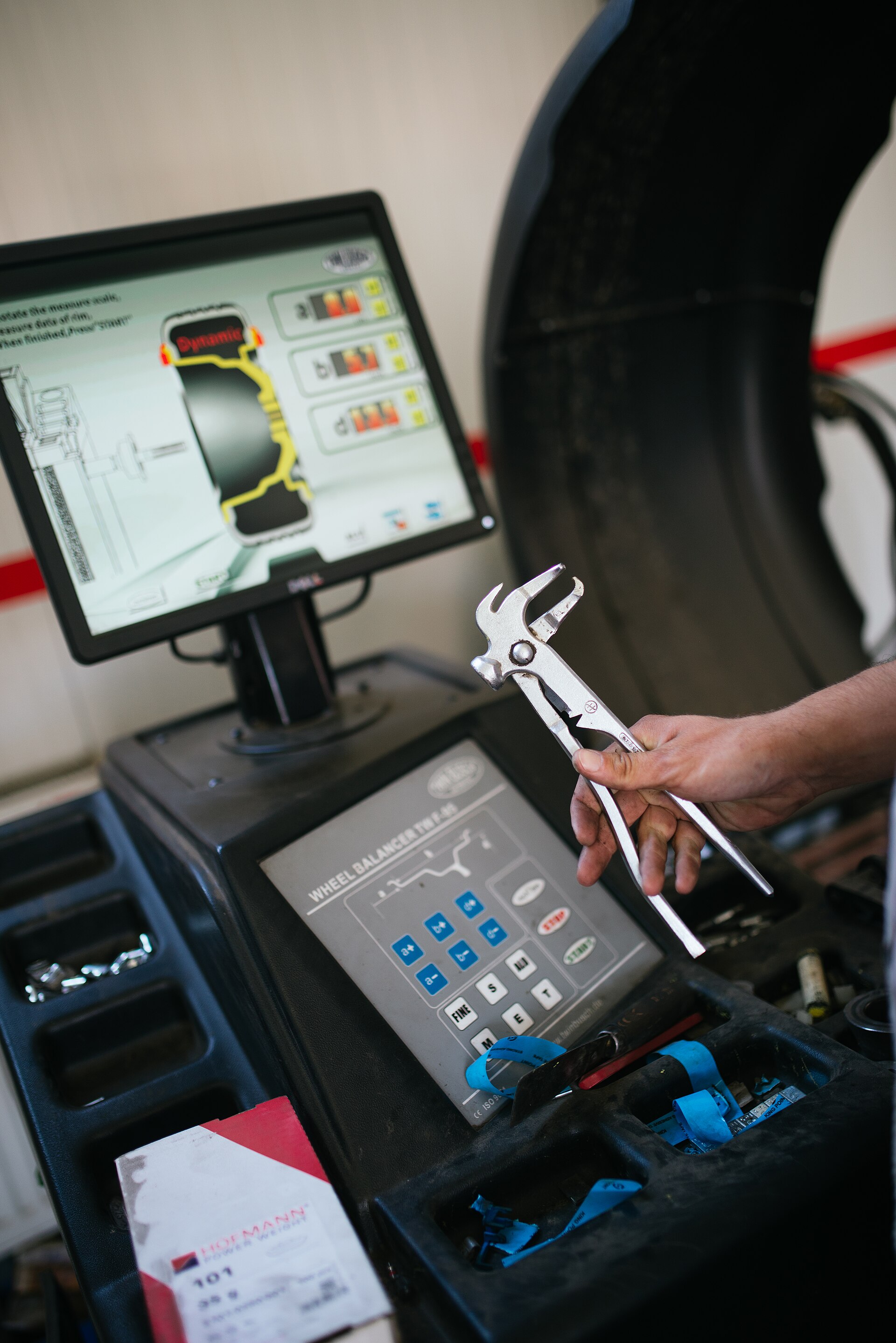 A mechanic working on a car in a service center