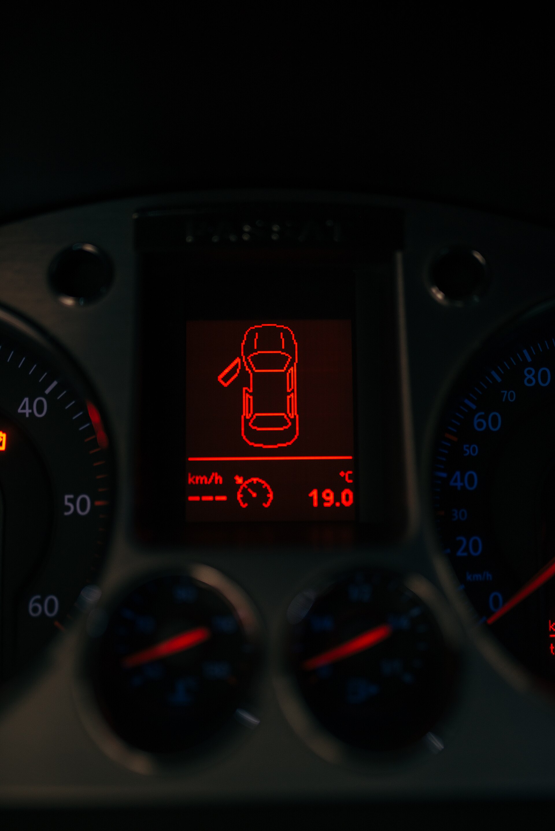 Dashboard display showing warning lights in a vehicle at night