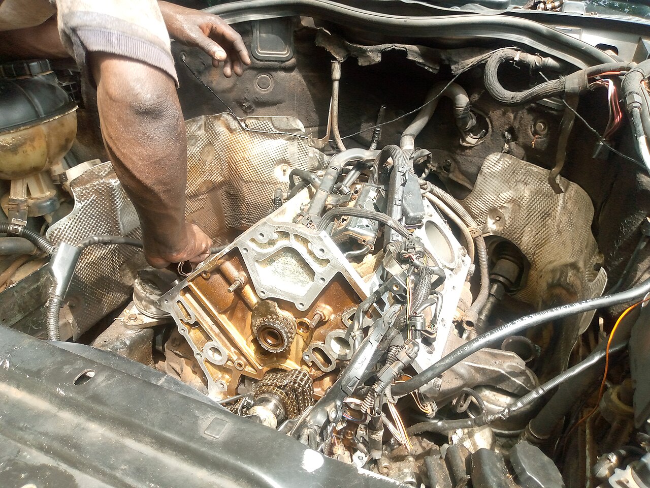 An open car engine bay showing the engine and surrounding parts