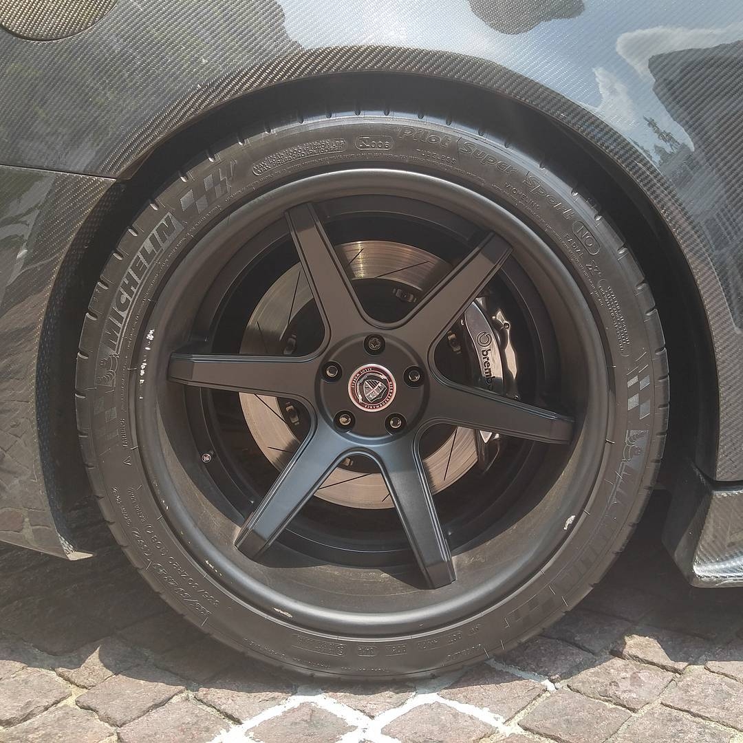A car wheel and tire viewed from the side
