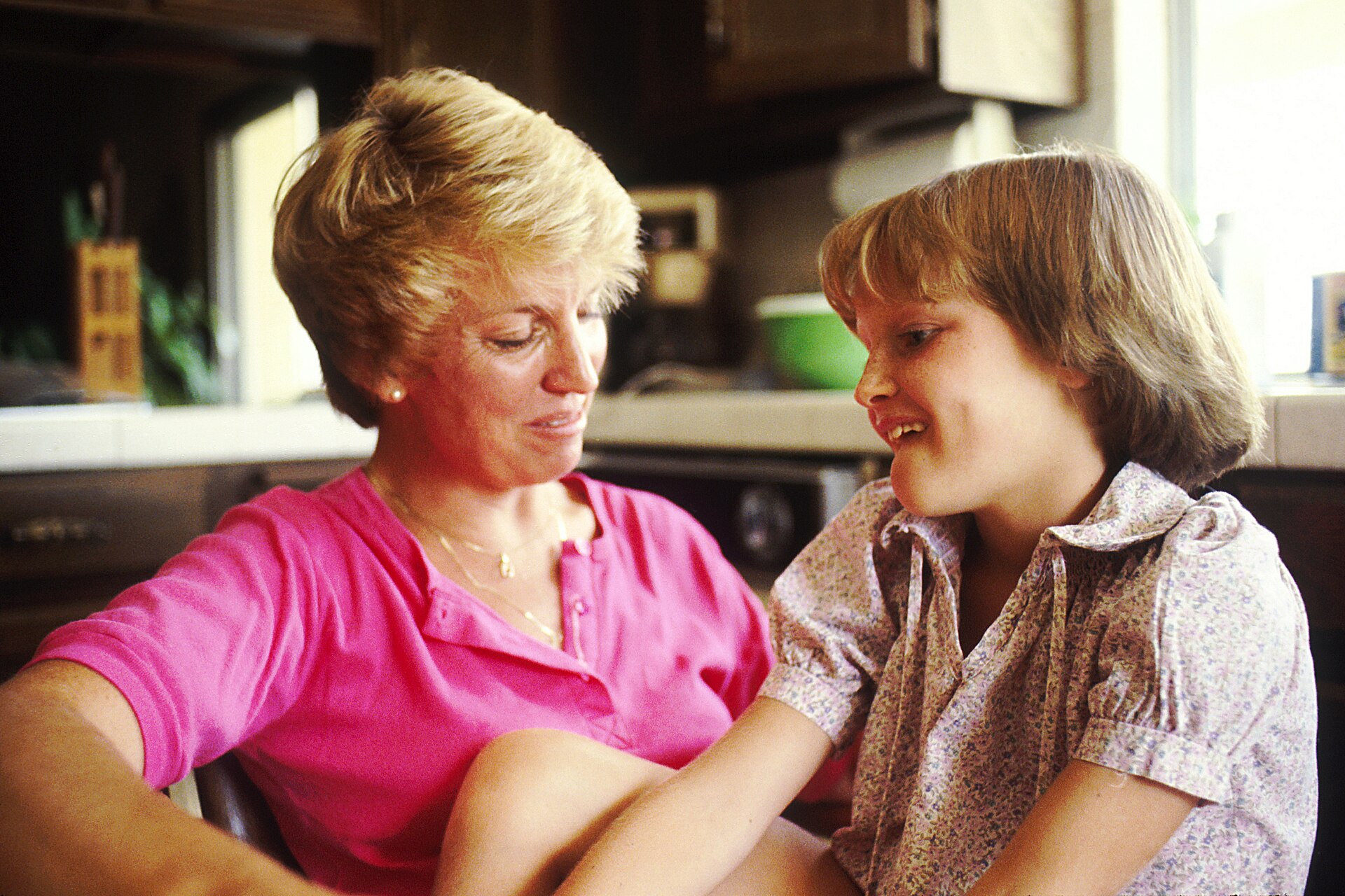 A mother and daughter talking together at home