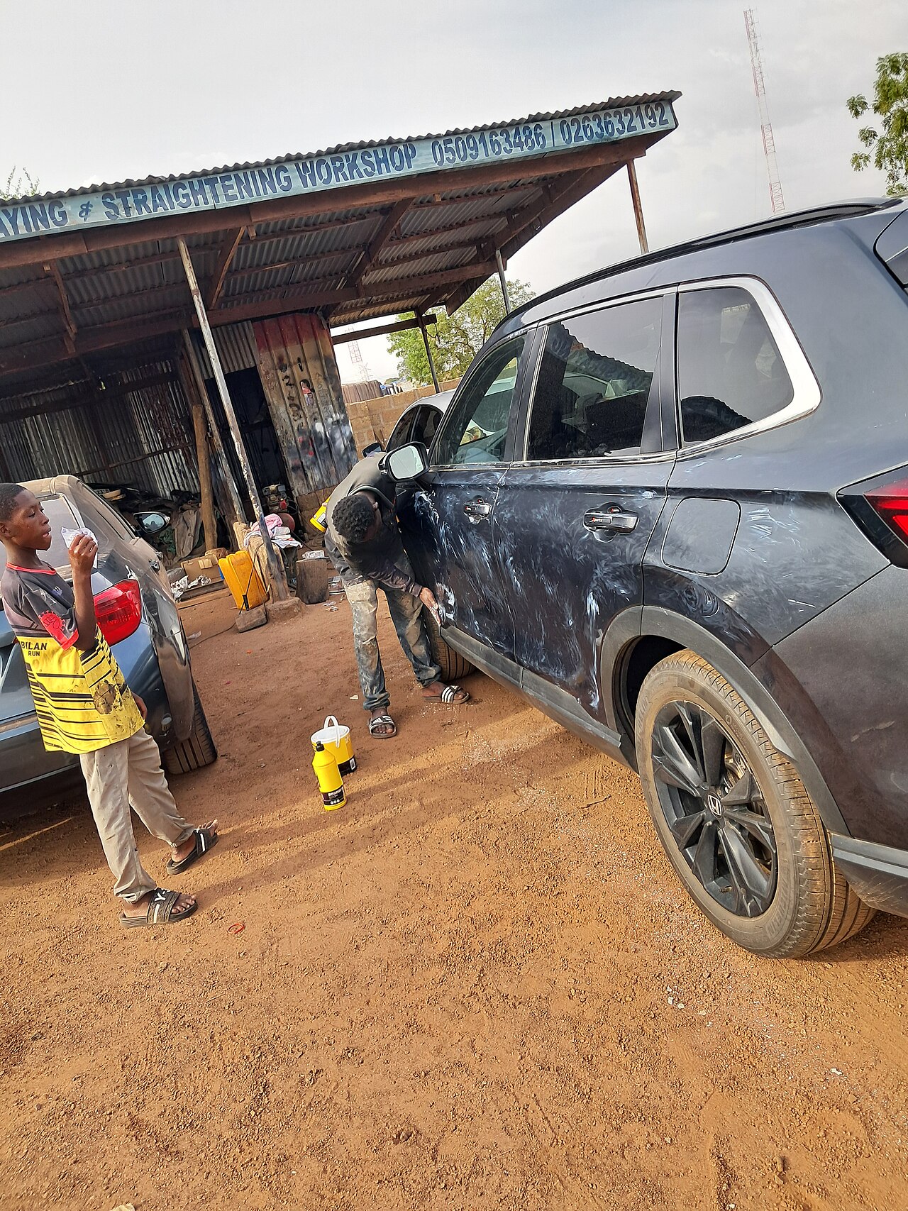 A car being polished after spraying