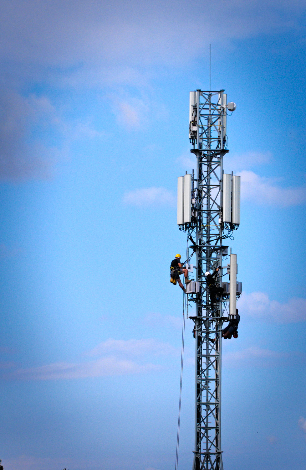 Workers servicing a cell tower