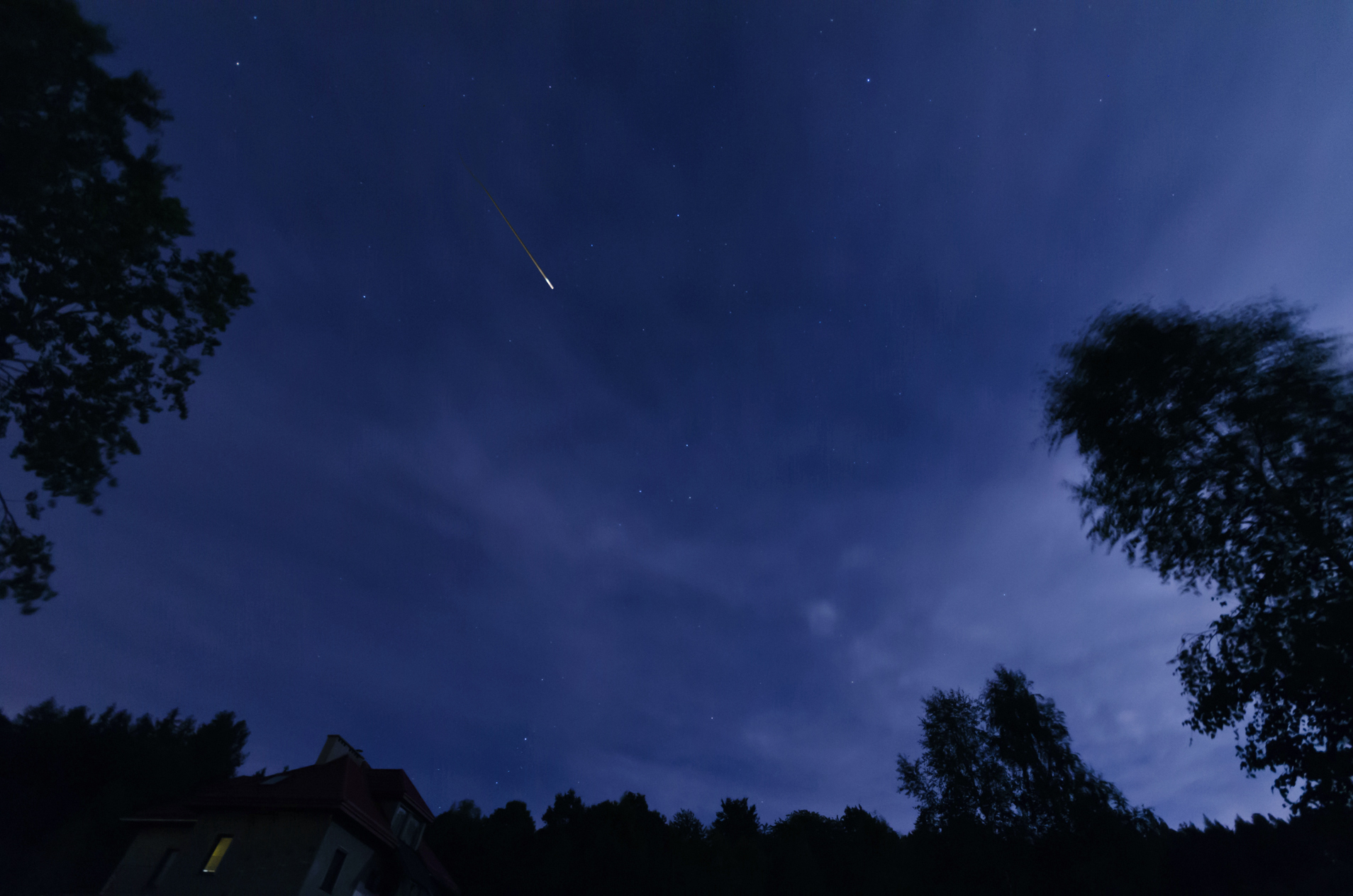A bright meteor streaking across a dark night sky