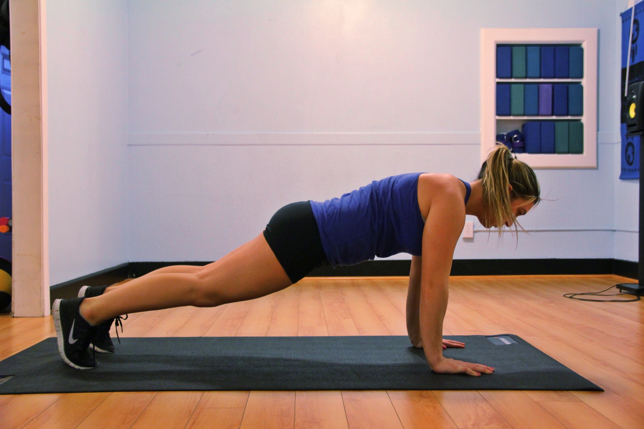 A person holding a plank position on a mat