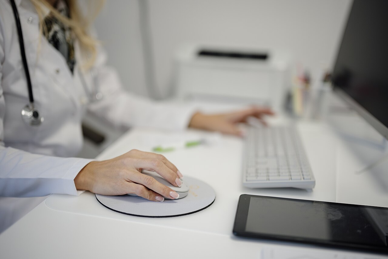 A person working at a desk computer in a medical office