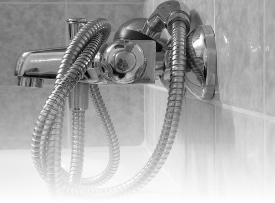 A handheld shower head with its hose connection