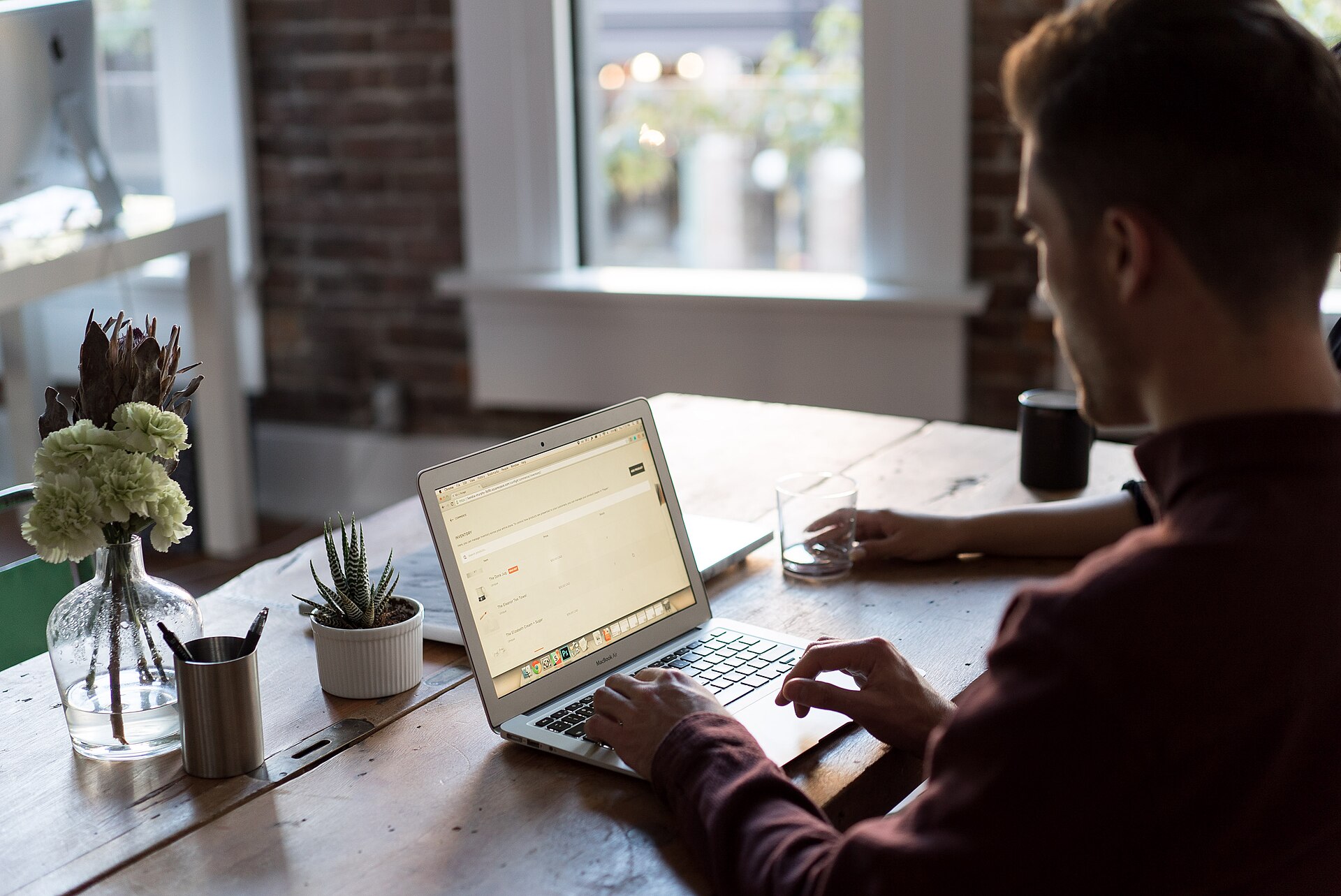 A man working at a laptop in an office