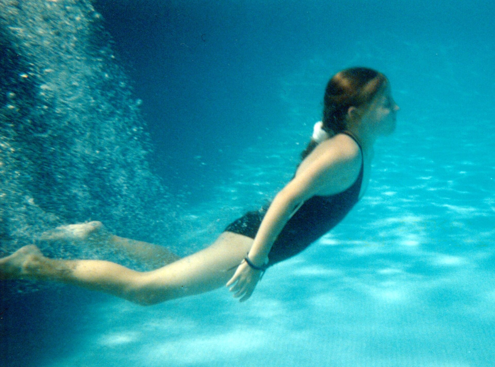 A girl underwater in a swimming pool