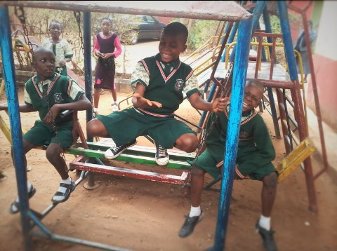Children playing and laughing on a swing