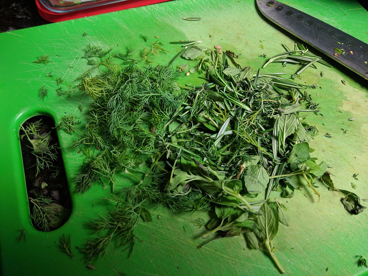 Chopping fresh herbs on a board