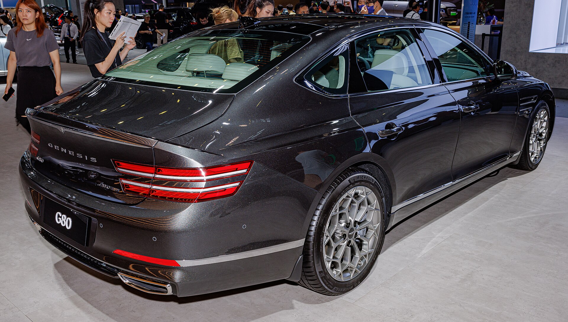 A Genesis G80 sedan parked at a car show