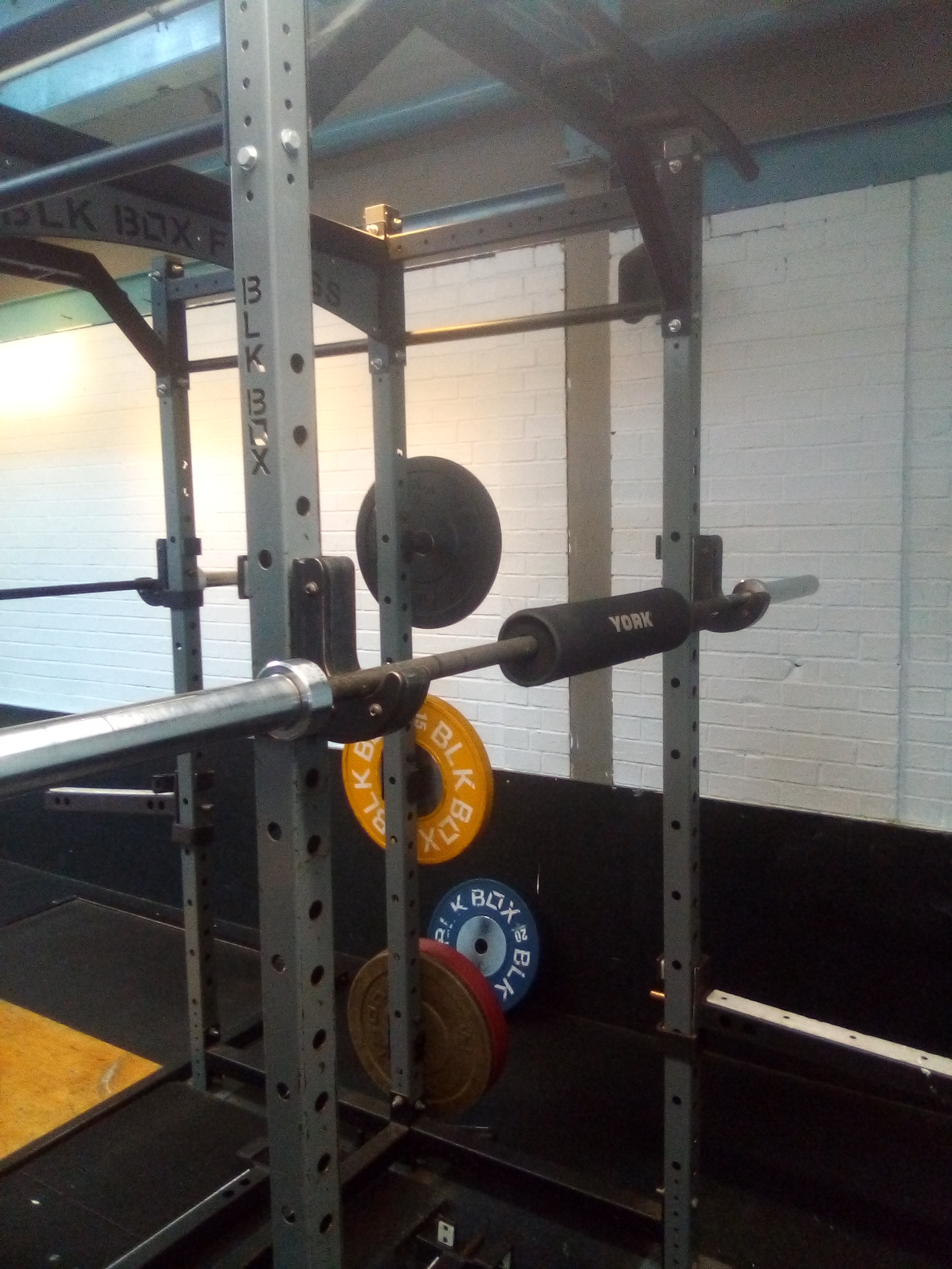 A lifter performing a barbell back squat