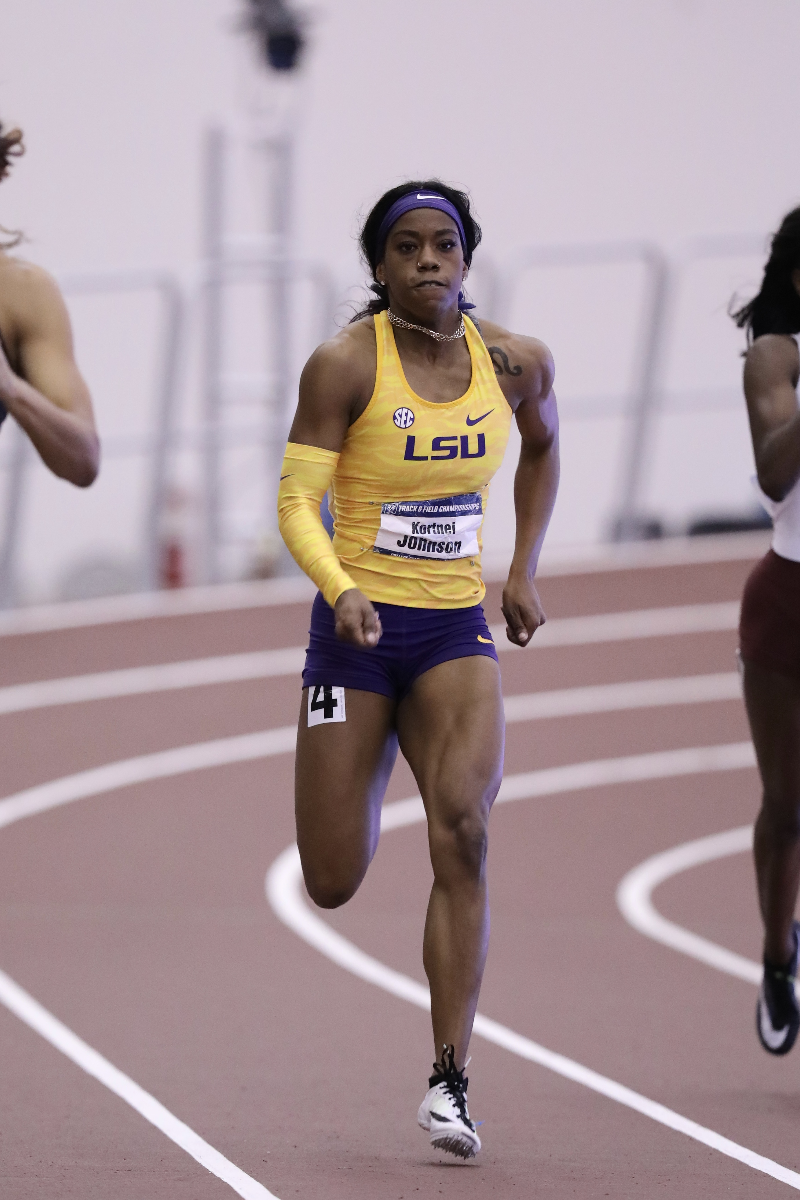 A track runner competing on an indoor track
