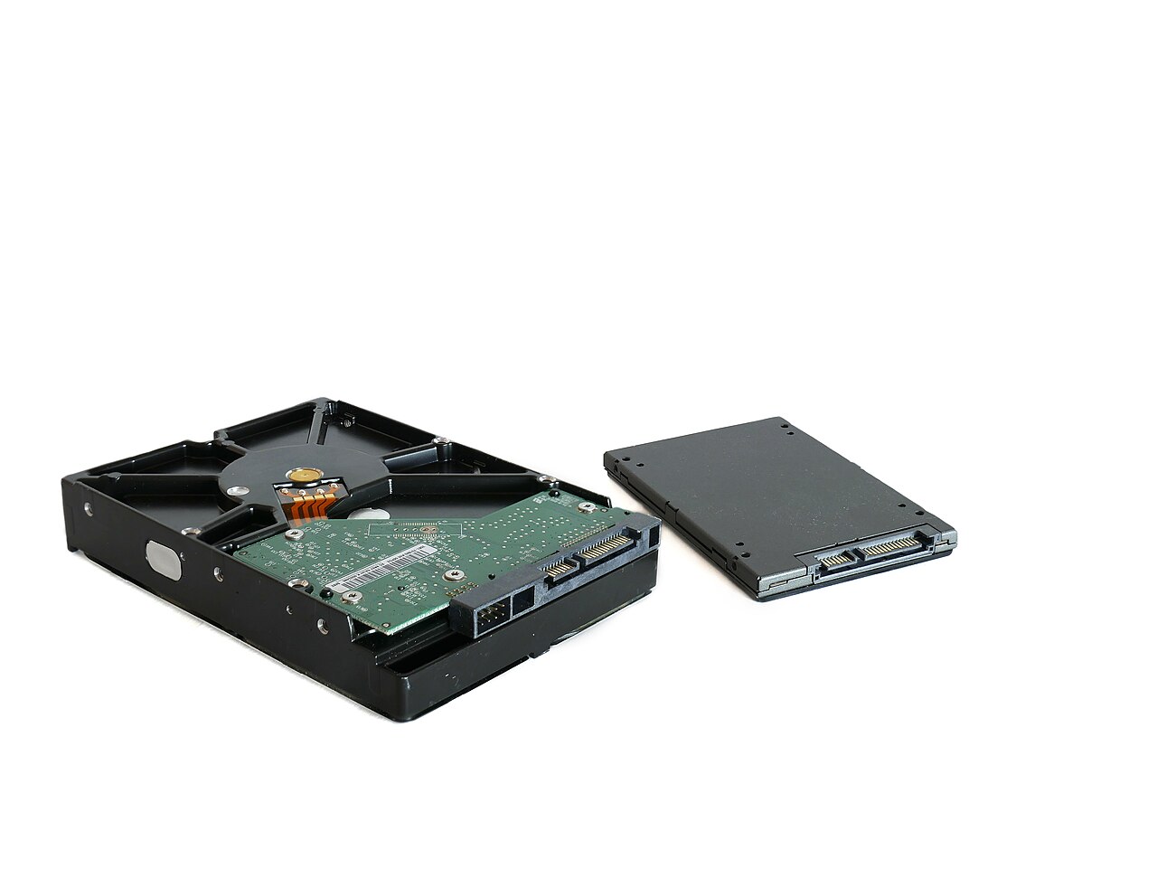 A mechanical hard drive beside a solid-state drive