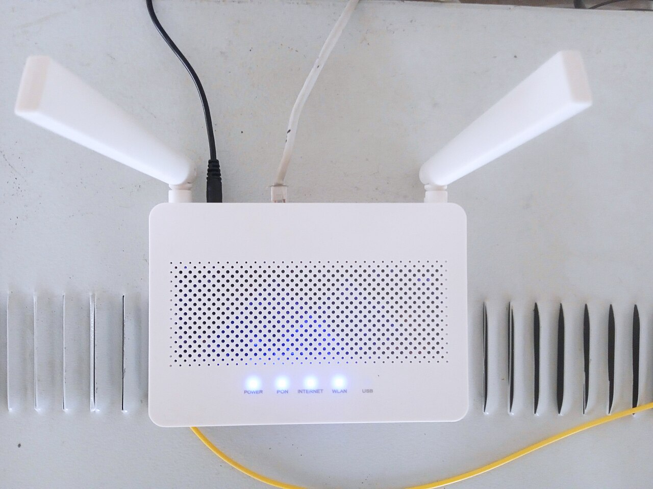 A Wi-Fi router with antennas on a shelf