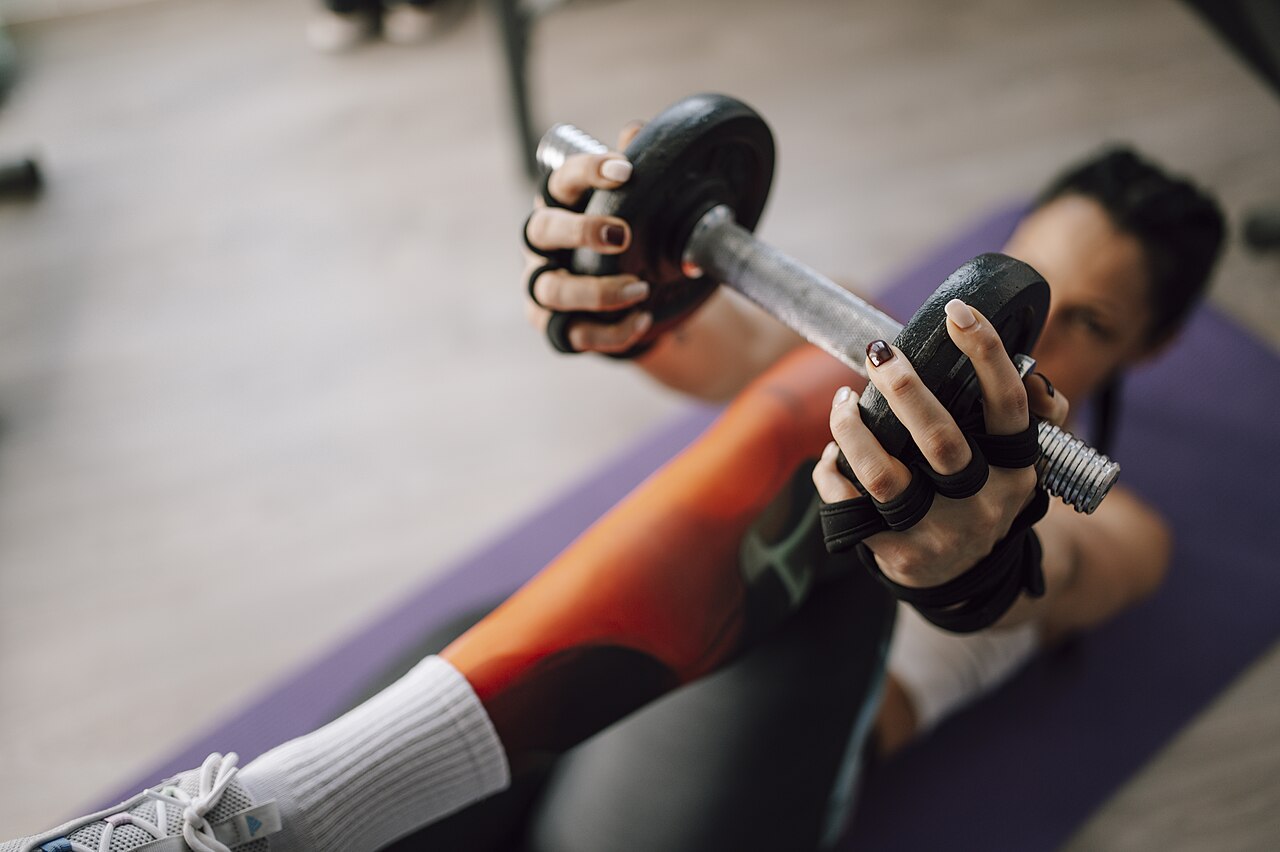 A close view of a person gripping a weight during a gym workout