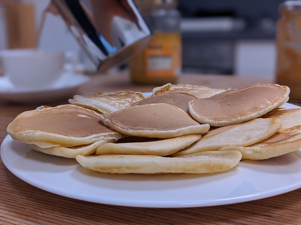 A stack of pancakes on a table ready to serve