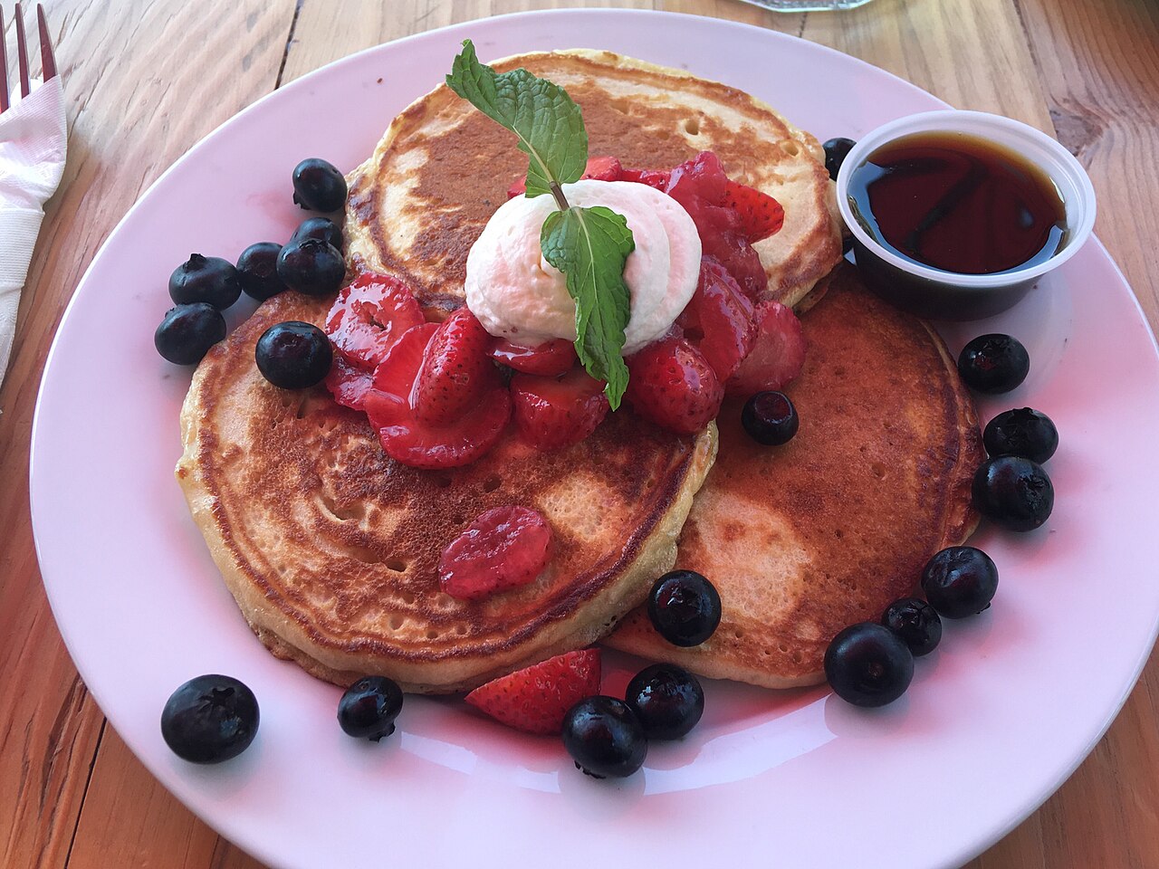 Pancakes topped with fruit on a plate