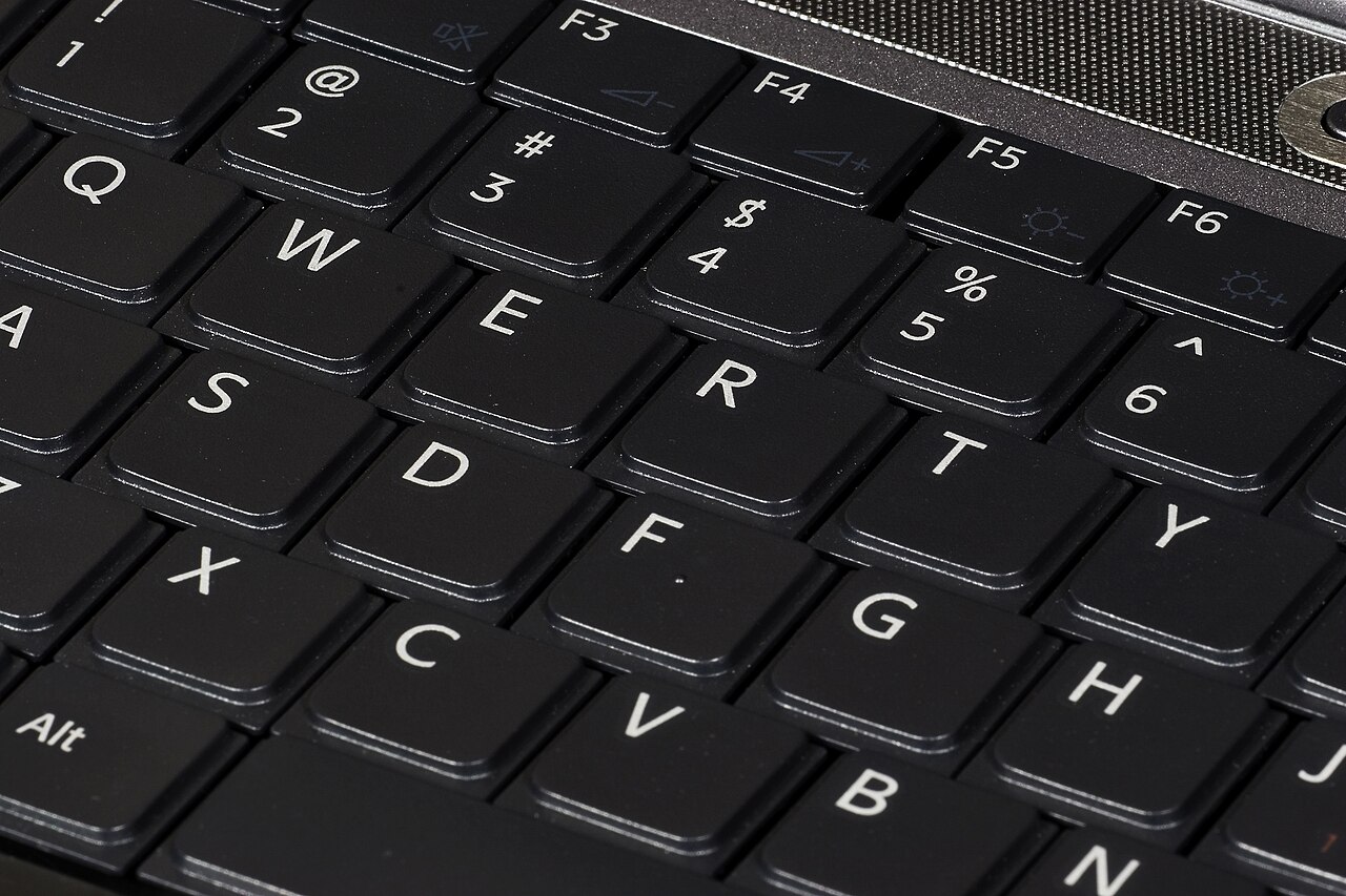 A computer keyboard with dark keys
