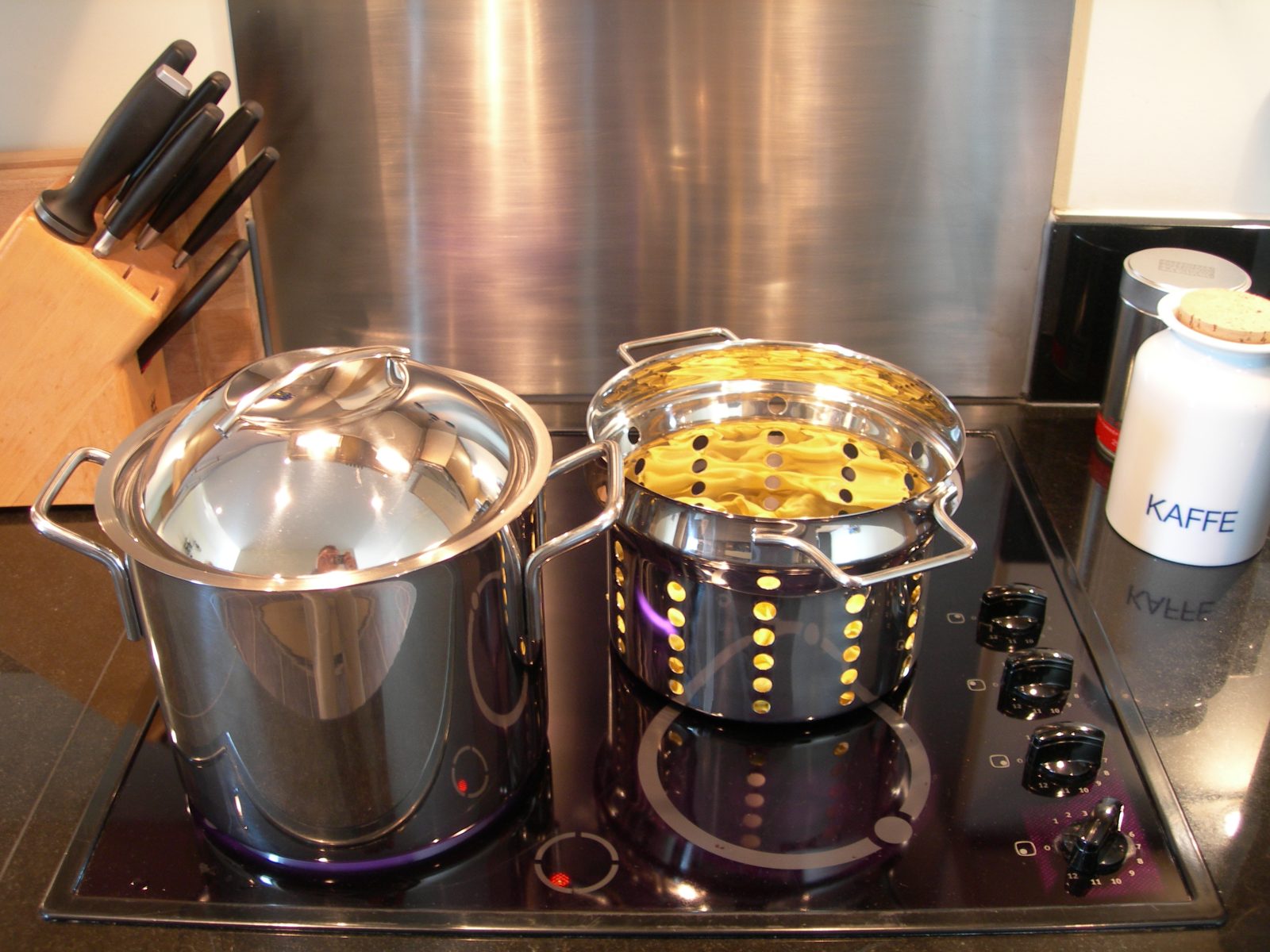 A pot of pasta with a spoon resting beside it