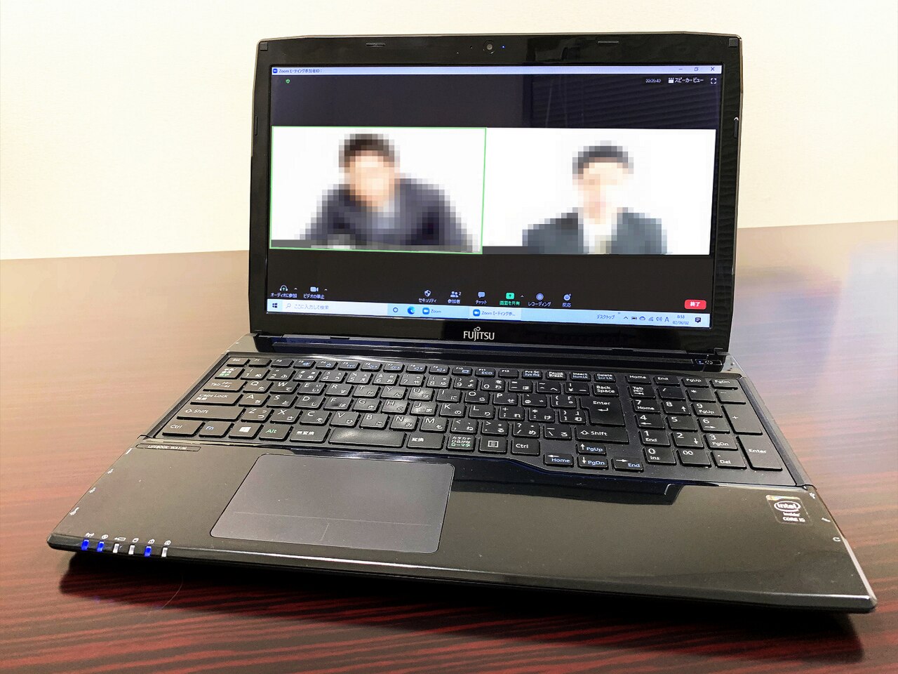 A video call in progress on a laptop